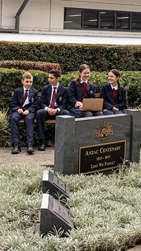 Marian Catholic College students sitting outside by the Anzac Centenary